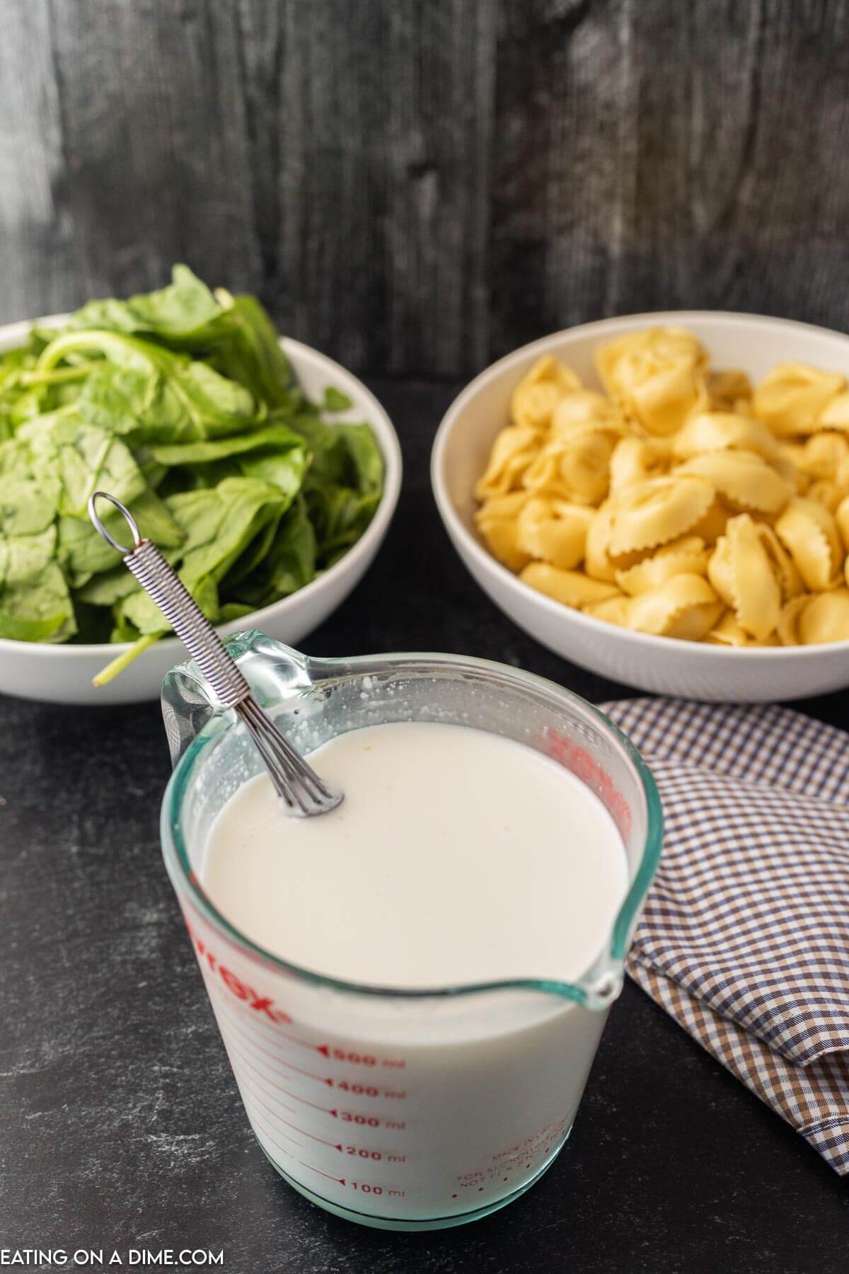 Mixing the cream and the cornstarch together in a measuring cup with a whisk