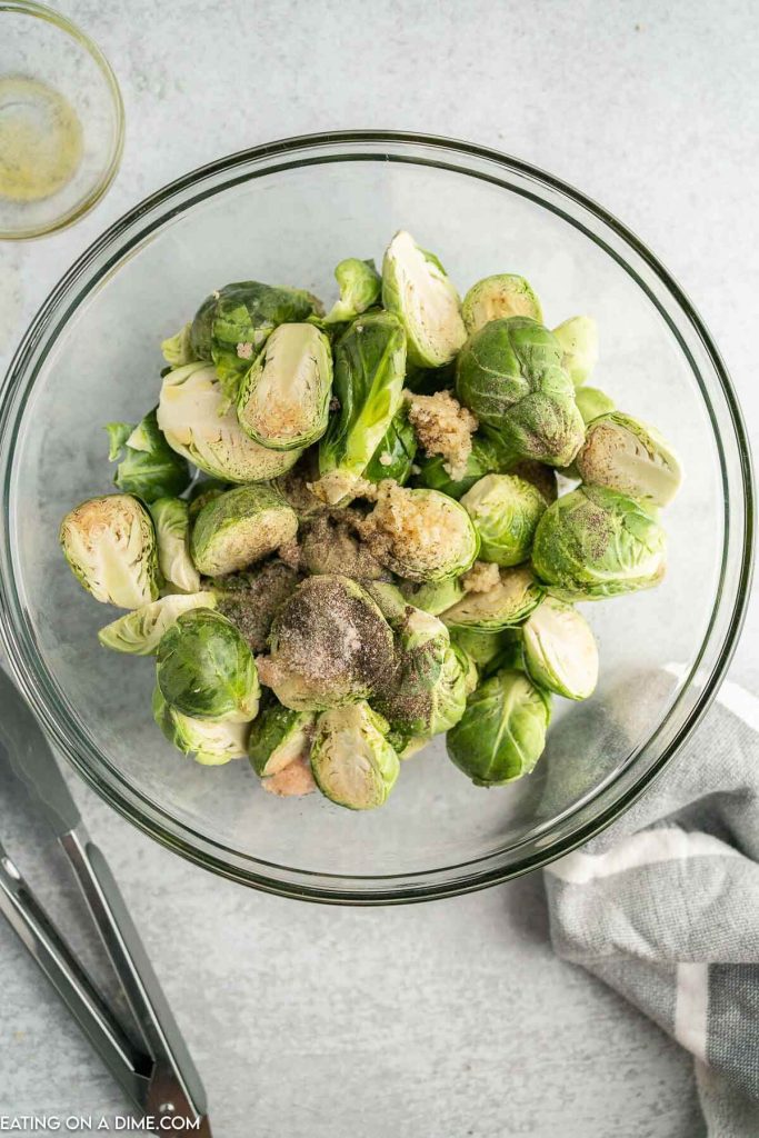 adding the seasoning to the brussel sprouts