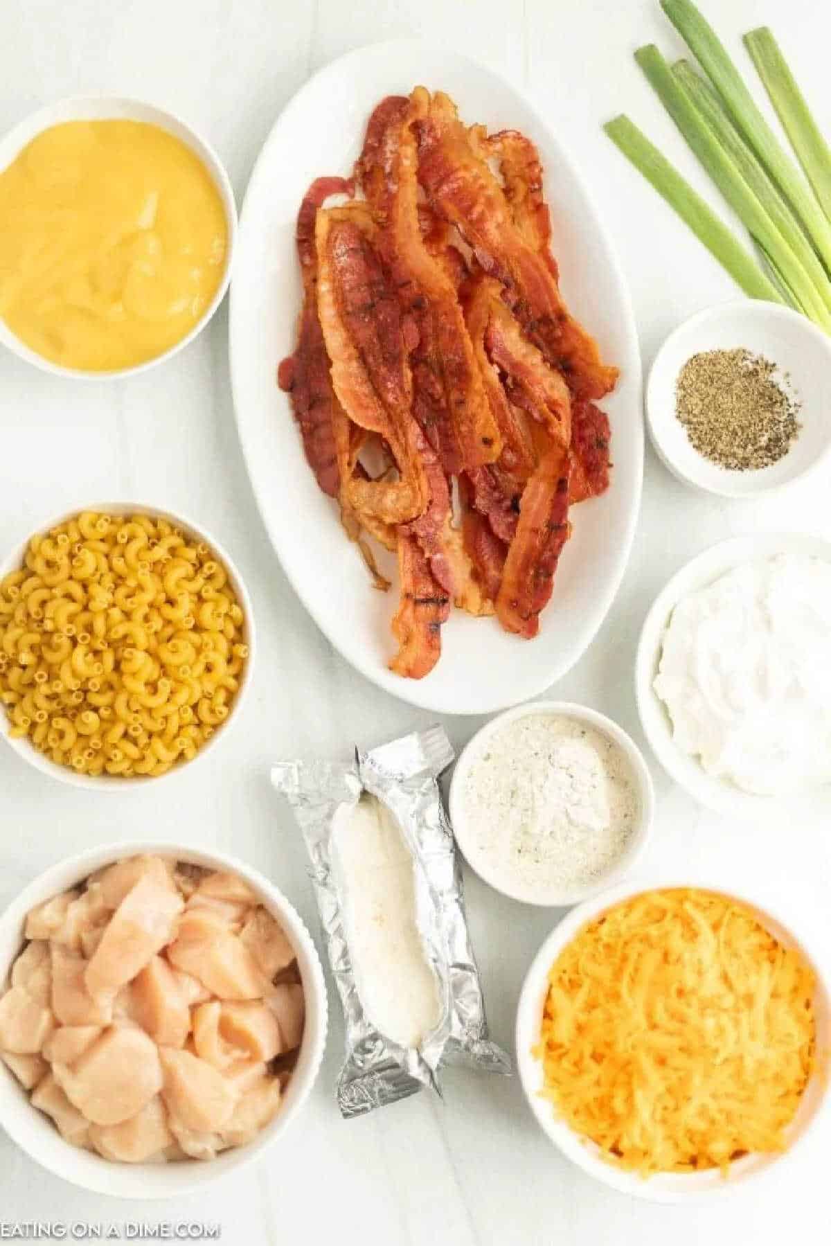 Ingredients needed - macaroni, chicken breast, bacon, cream cheese, sour cream, chicken broth, ranch dressing mix, black pepper, cheese, green onions.