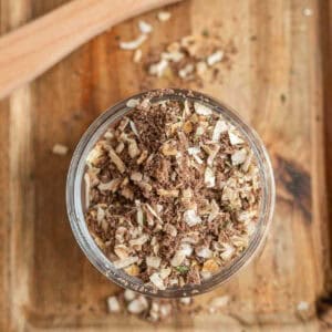 Homemade onion soup mix in a bowl on a wooden platter.