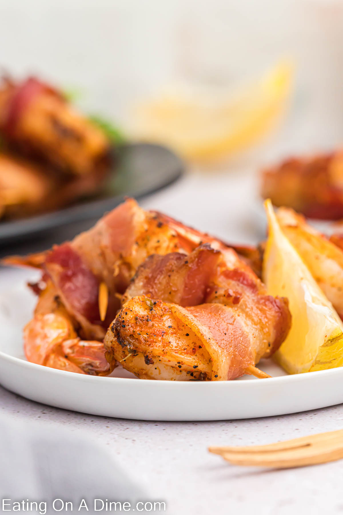 Bacon wrapped shrimp on a platter. 