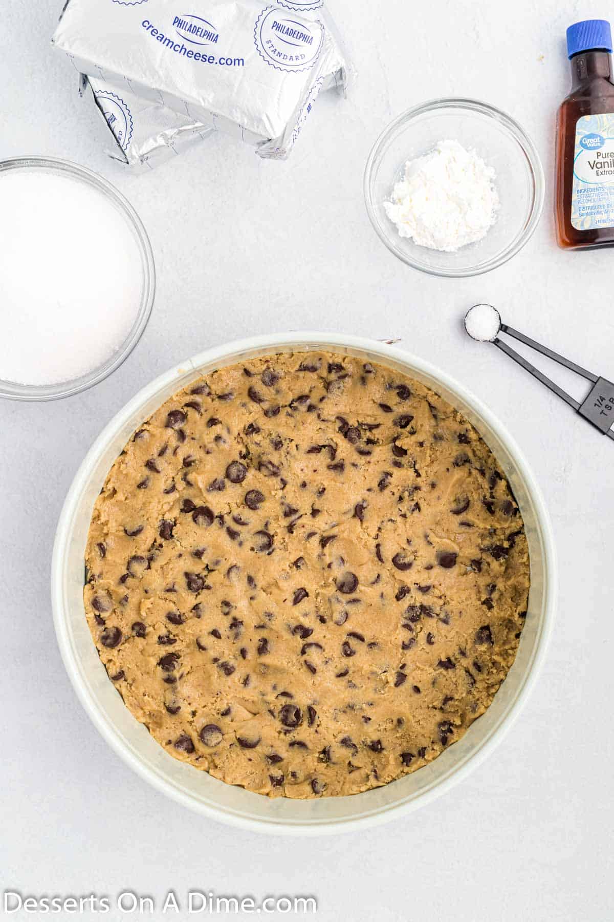 Pressing cookie dough into the baking dish