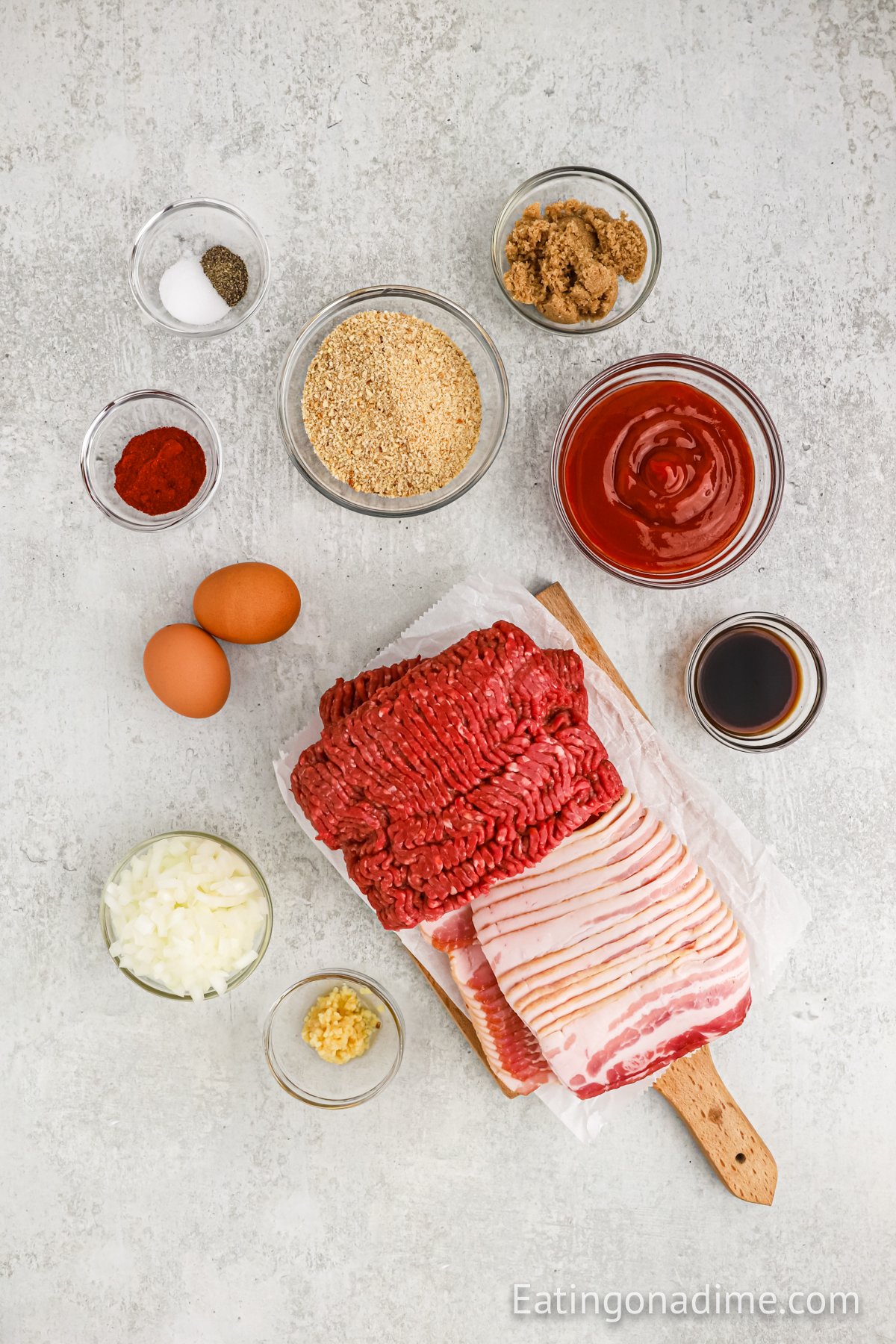 Ingredients needed - ground beef, breadcrumbs, onion, eggs, worcestershire sauce, garlic, salt and pepper, bacon, ketchup, brown sugar, paprika