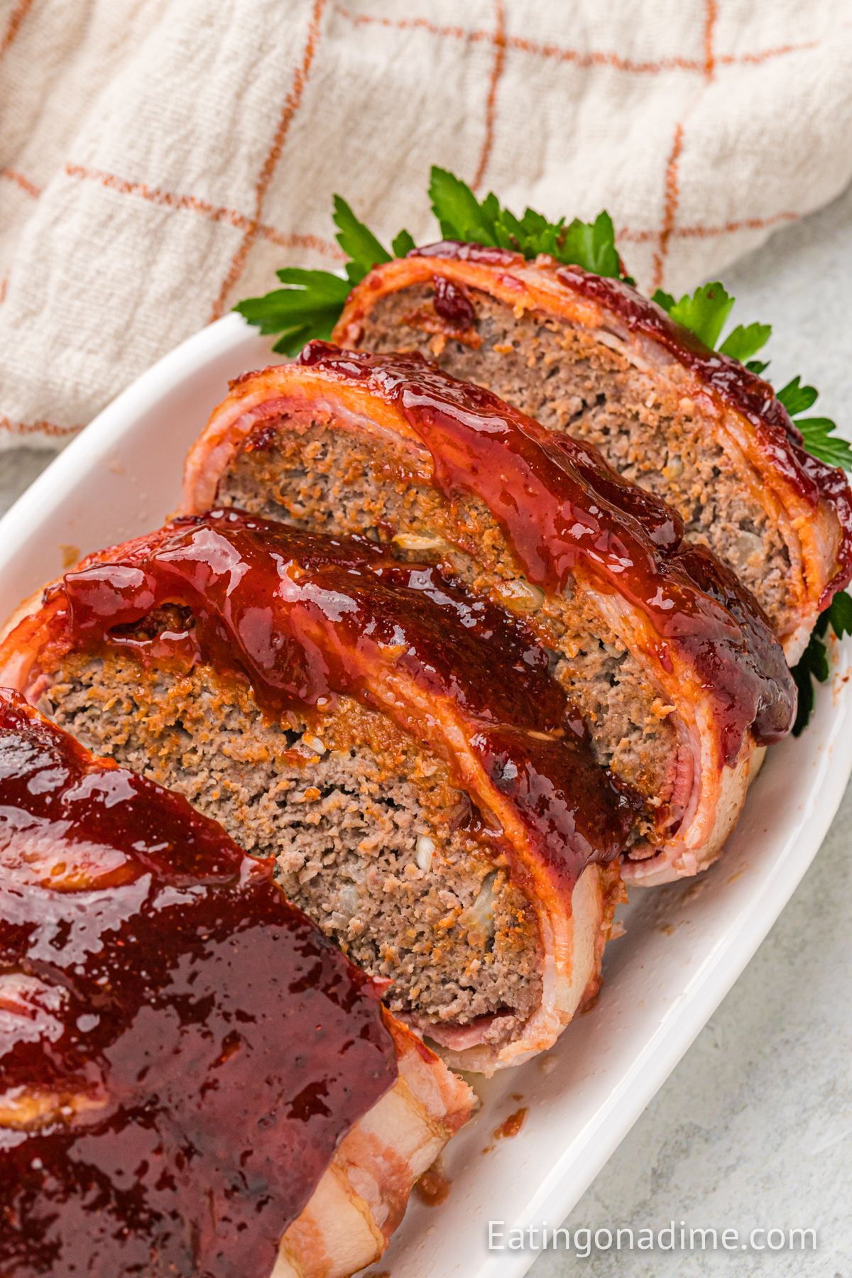 Bacon Wrapped Meatloaf on a platter sliced