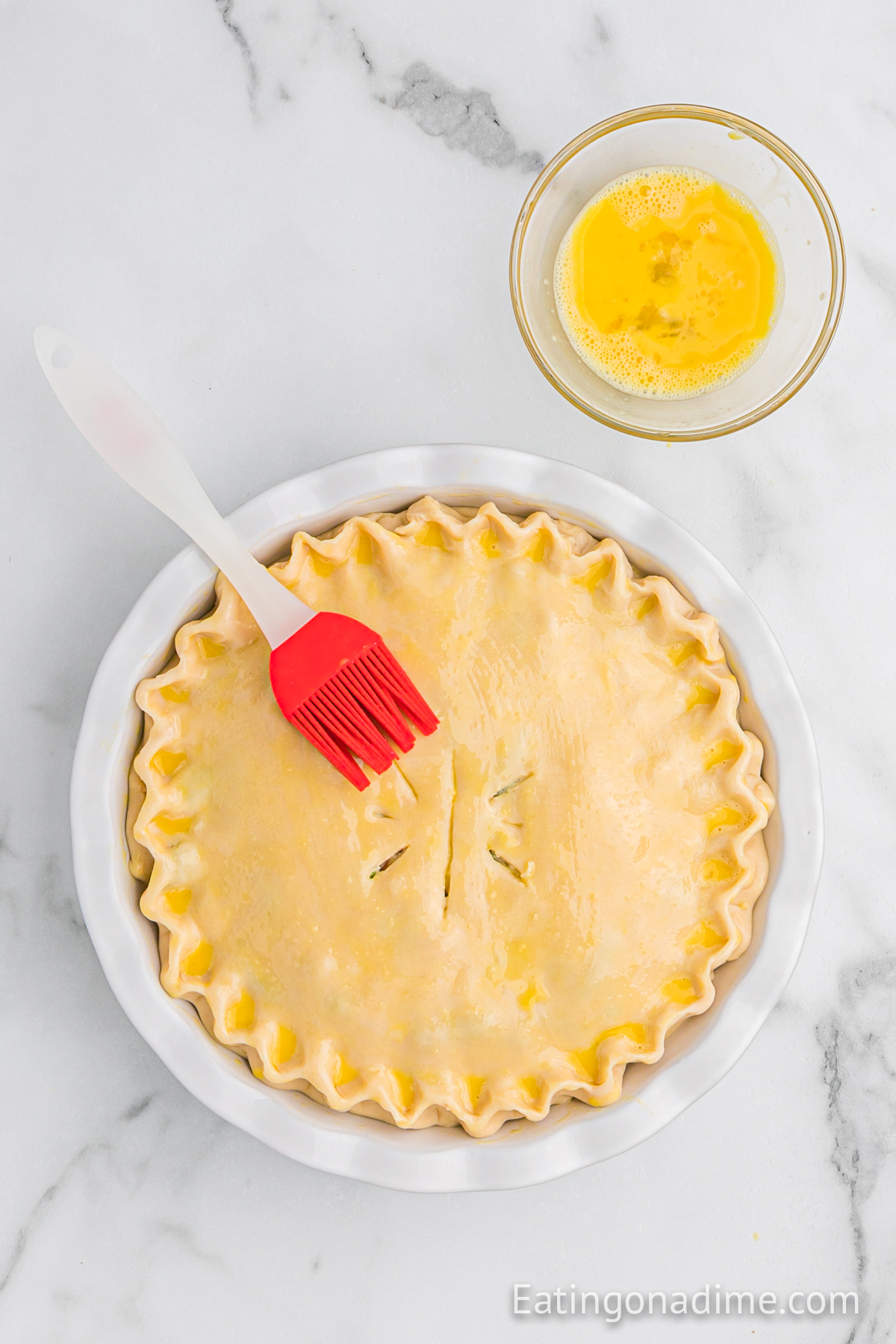 Brush the egg wash over the top pie crust
