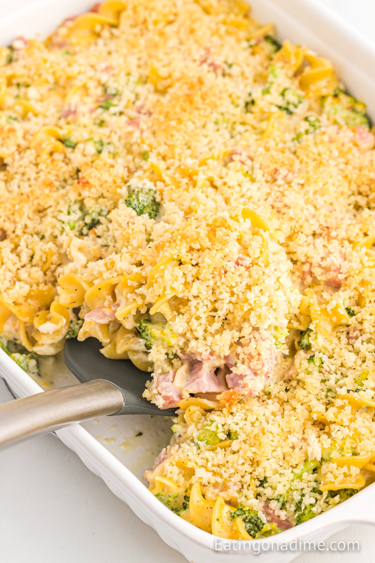 leftover ham casserole in a baking dish with spatula