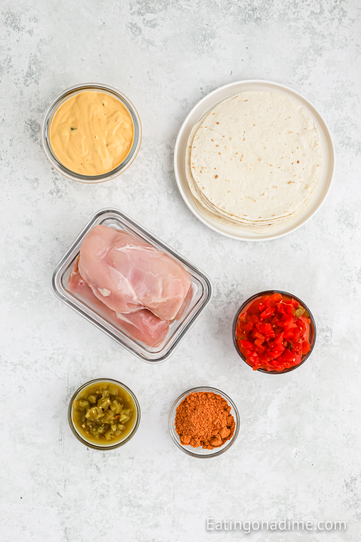 Ingredients needed - chicken breast, taco seasoning, diced tomatoes with green chiles, green chiles, salsa con queso, flour tortillas, taco toppings
