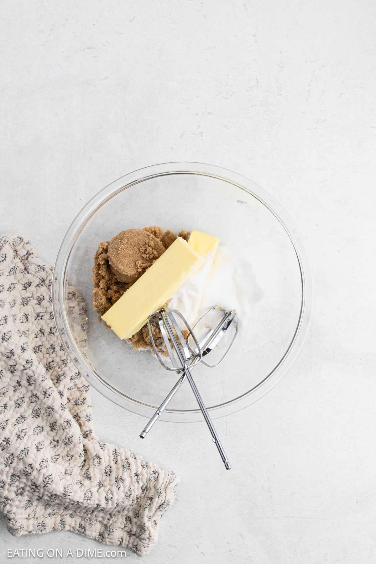 Brown sugar, sugar, and butter placed in a bowl.