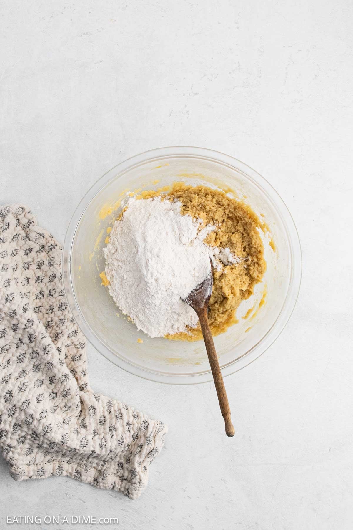 Flour mixture is added to the butter mixture in a bowl.