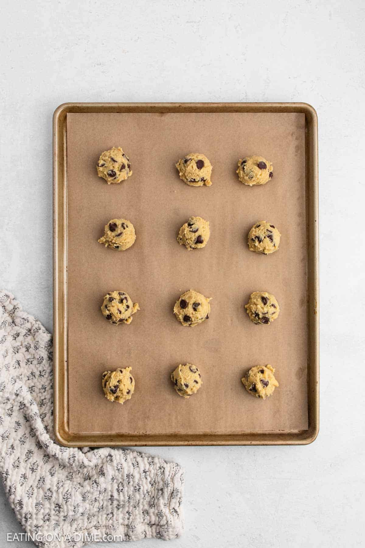 Cookie dough on a baking sheet lined with parchment paper.