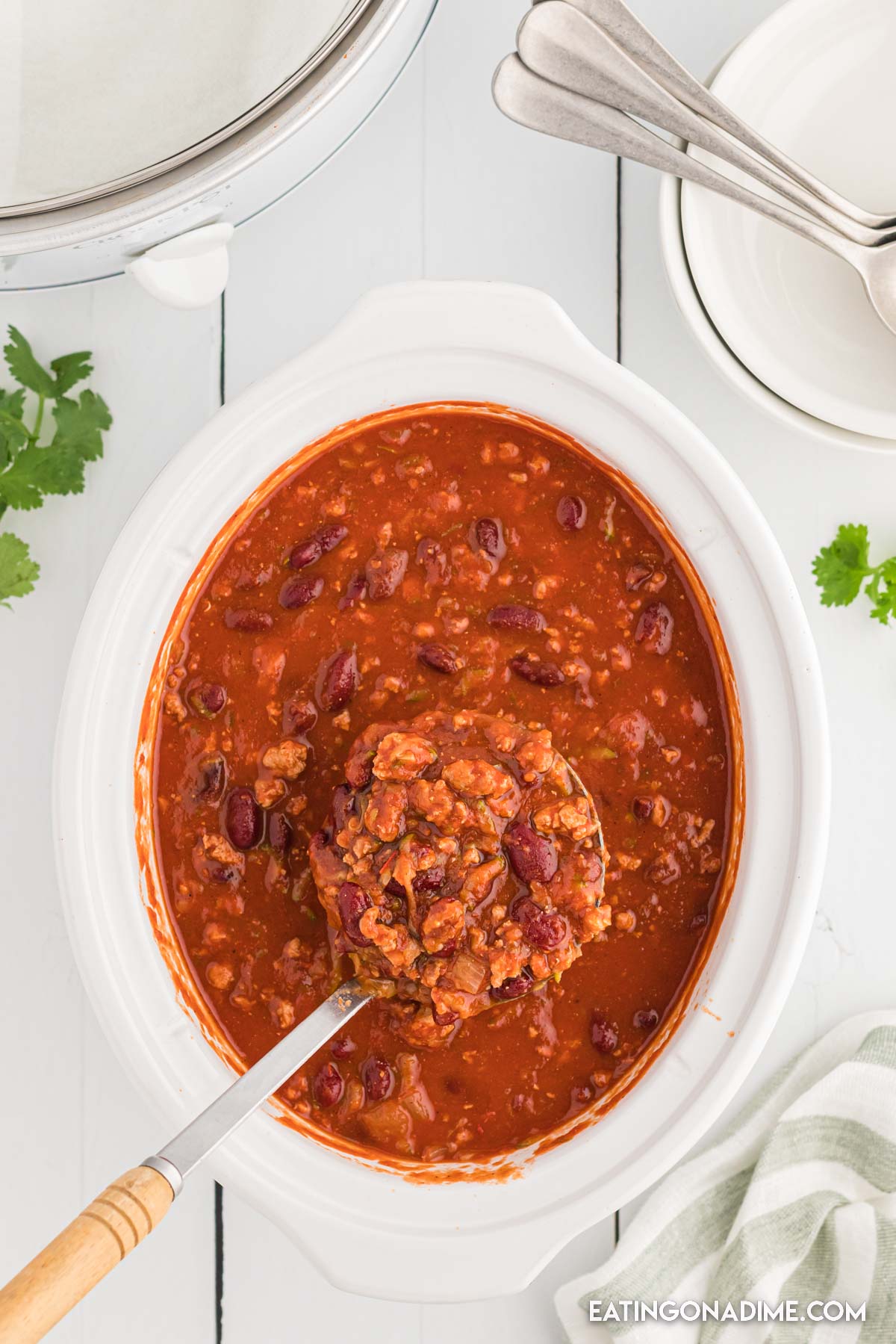 Turkey Chili in a slow cooker with a serving on a ladle