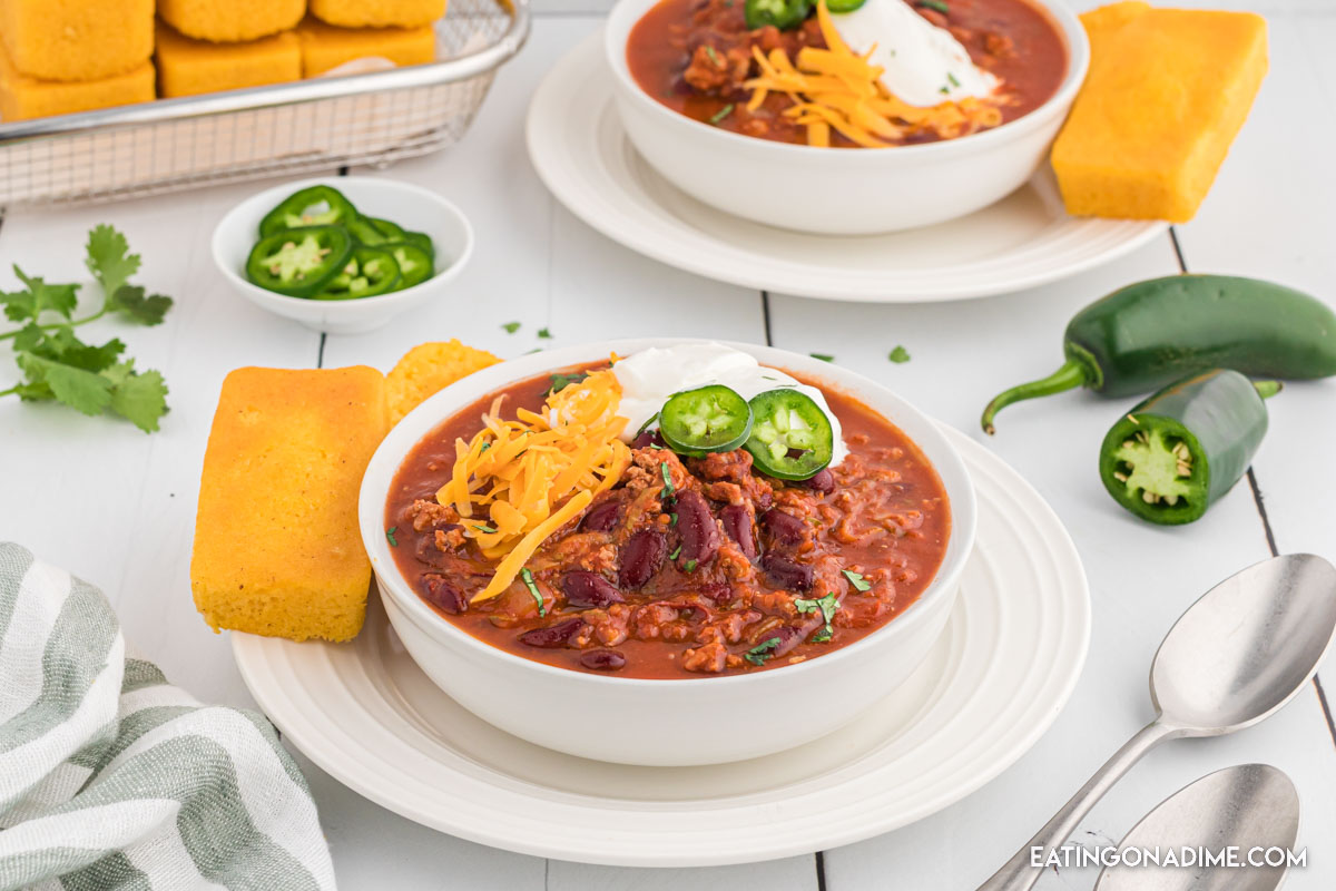 Turkey Chili in a bowl topped with cheese, sour cream and jalapenos