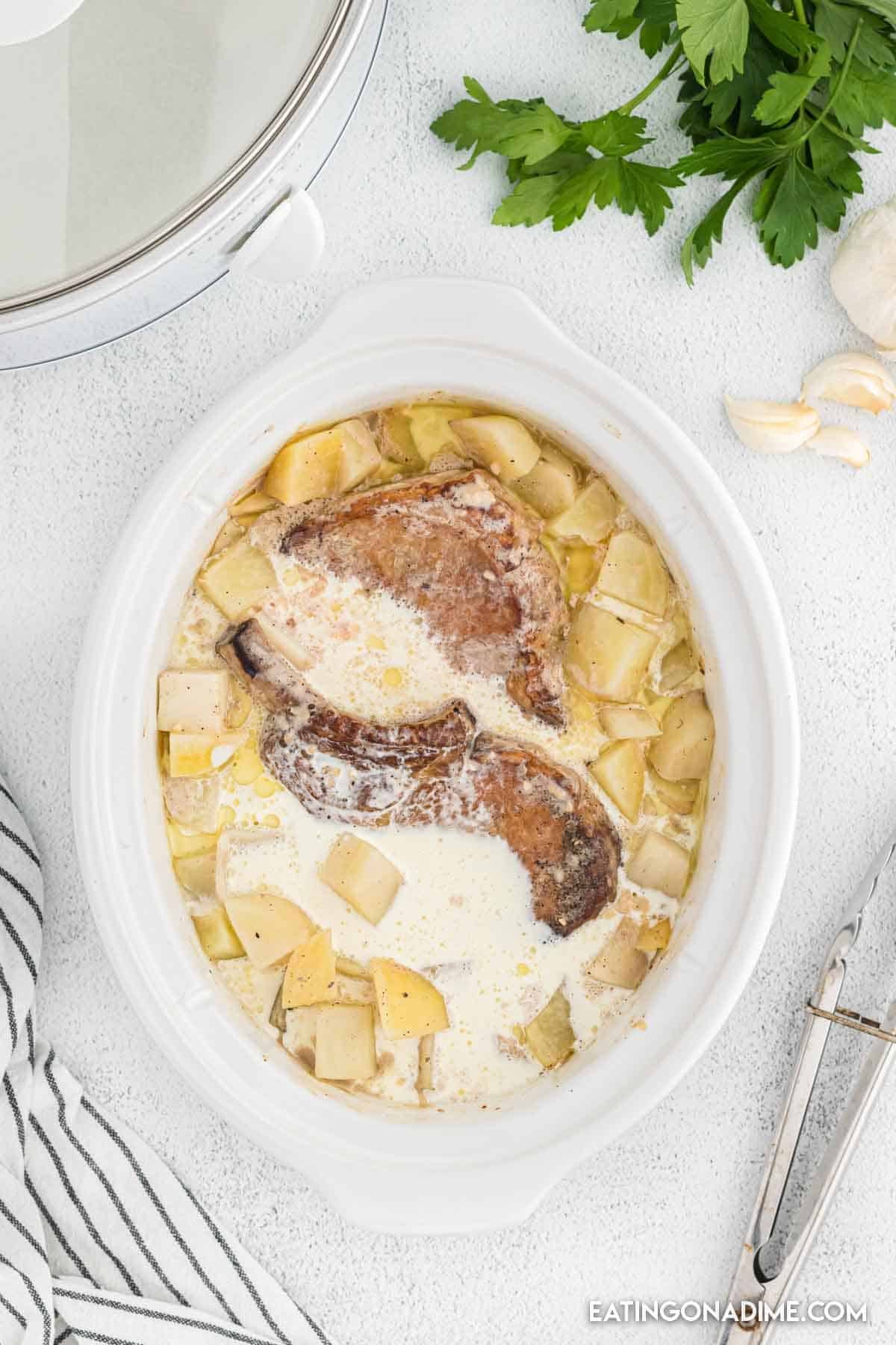 Pork chops in the crock pot with heavy cream and potatoes.