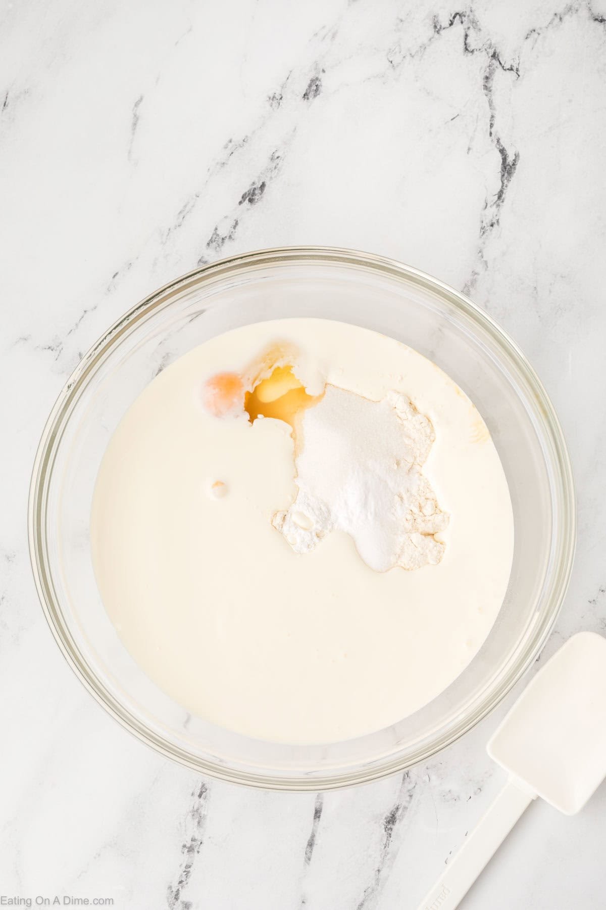 Combining the pancake ingredients in a bowl