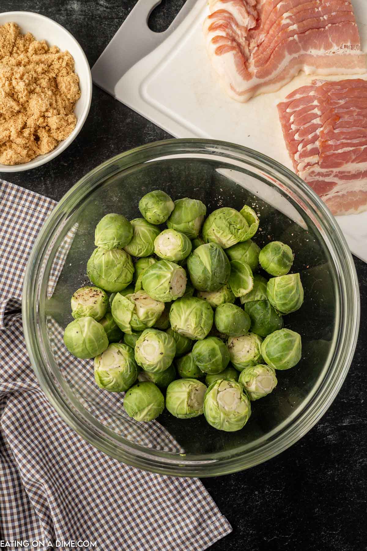 Brussel Sprouts in a bowl being mixed with seasoning