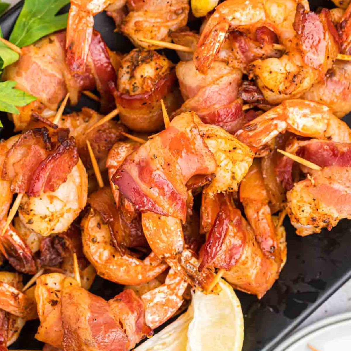 Bacon wrapped shrimp on a platter. 