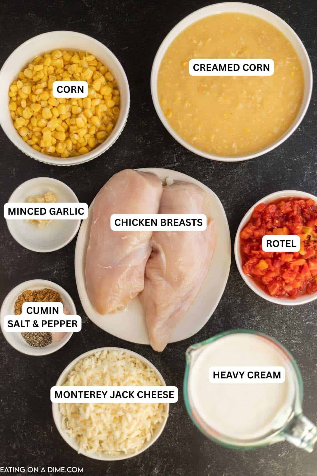 Ingredients for recipe: corn, creamed corn, minced garlic, chicken breasts, rotel, cumin, salt, pepper, monterey jack cheese and heavy cream.