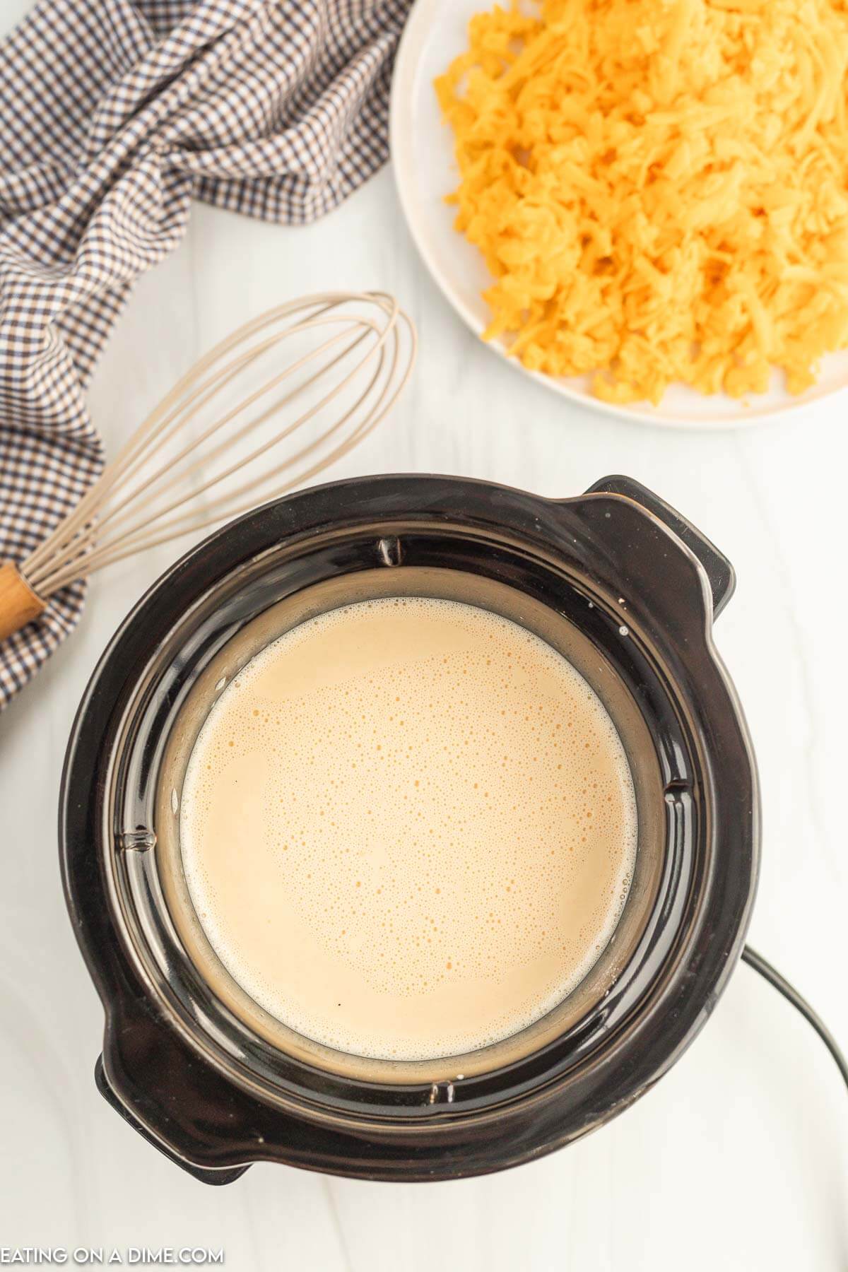 Mixing the milk, hot sauce, and cornstarch together in the slow cooker