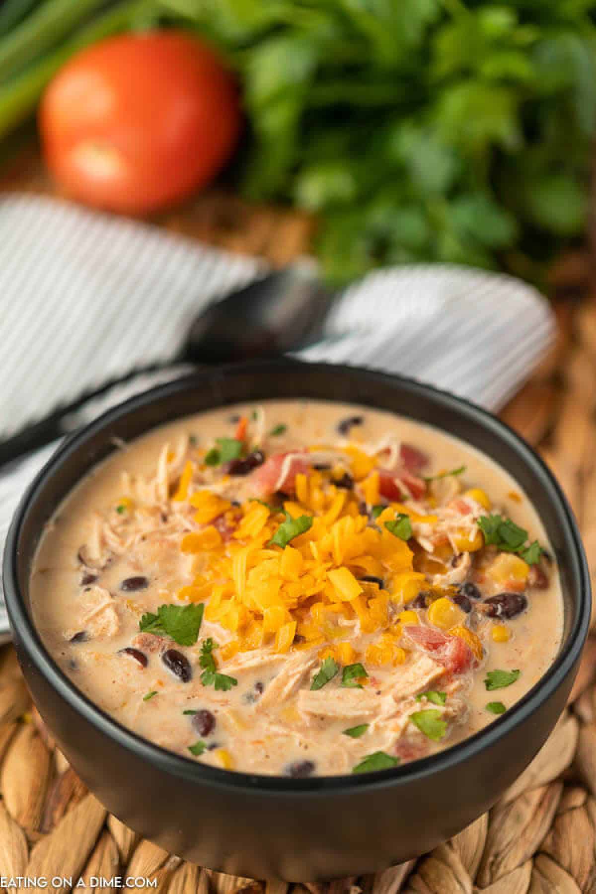 Try this Crockpot Creamy Chicken Taco Soup Recipe. It is so creamy and delicious. Not to mention easy! You will love creamy taco soup recipe! A black bowl of creamy chicken taco soup