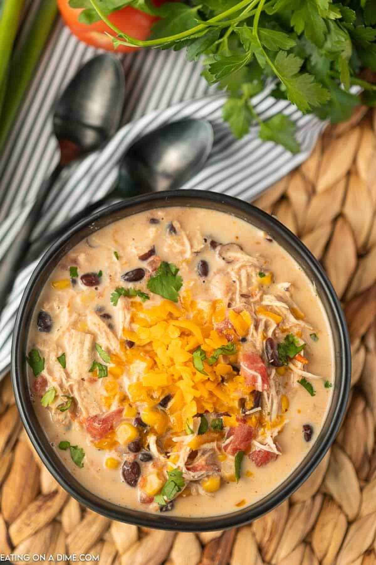 Try this Crockpot Creamy Chicken Taco Soup Recipe. It is so creamy and delicious. Not to mention easy! You will love creamy taco soup recipe! Creamy chicken taco soup in a black bowl