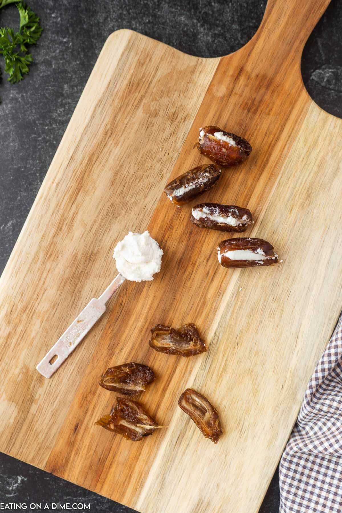 Stuffing the pitted dates with goat cheese