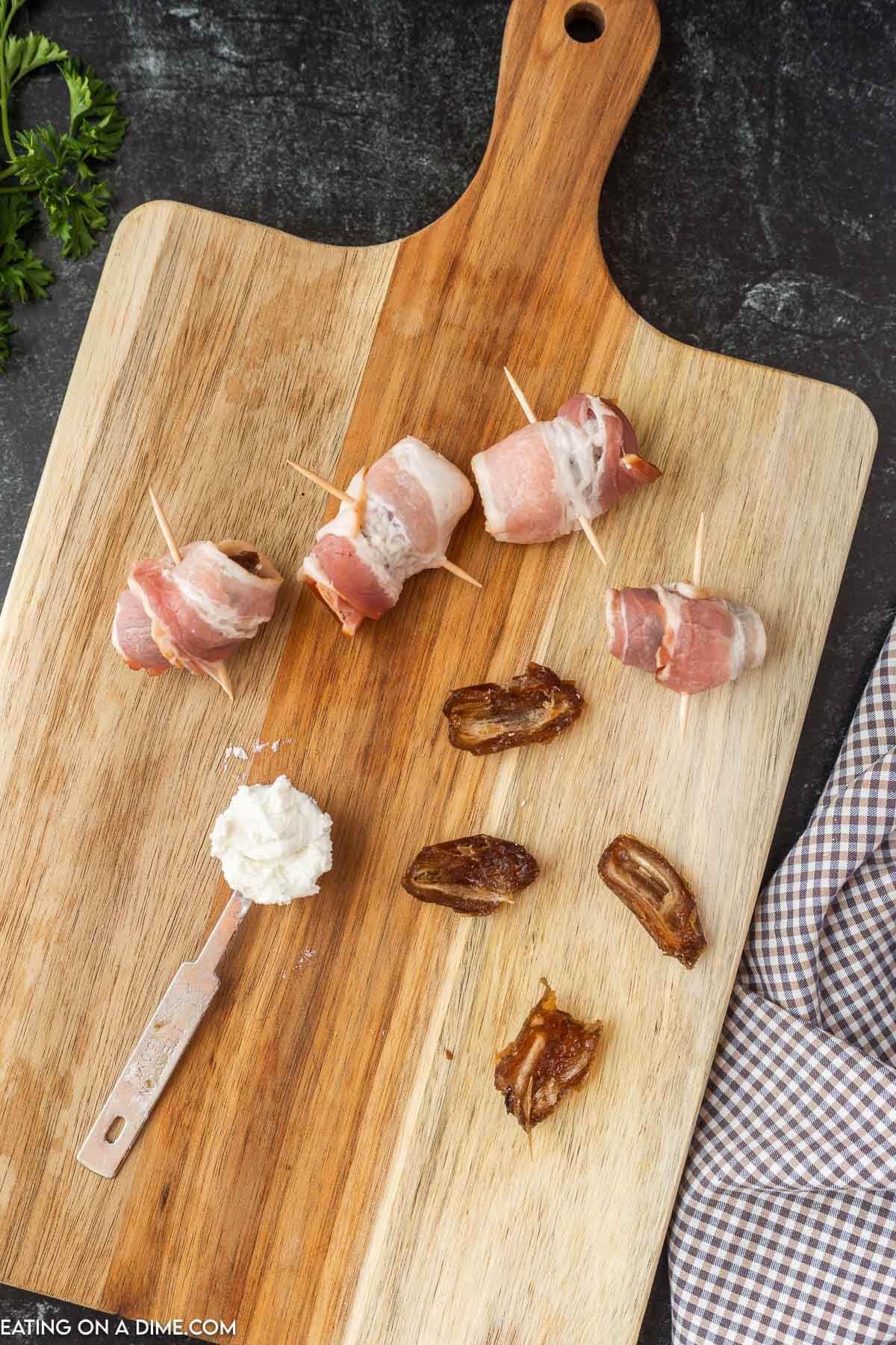 Bacon wrapped around dates with a tablespoon of goat cheese