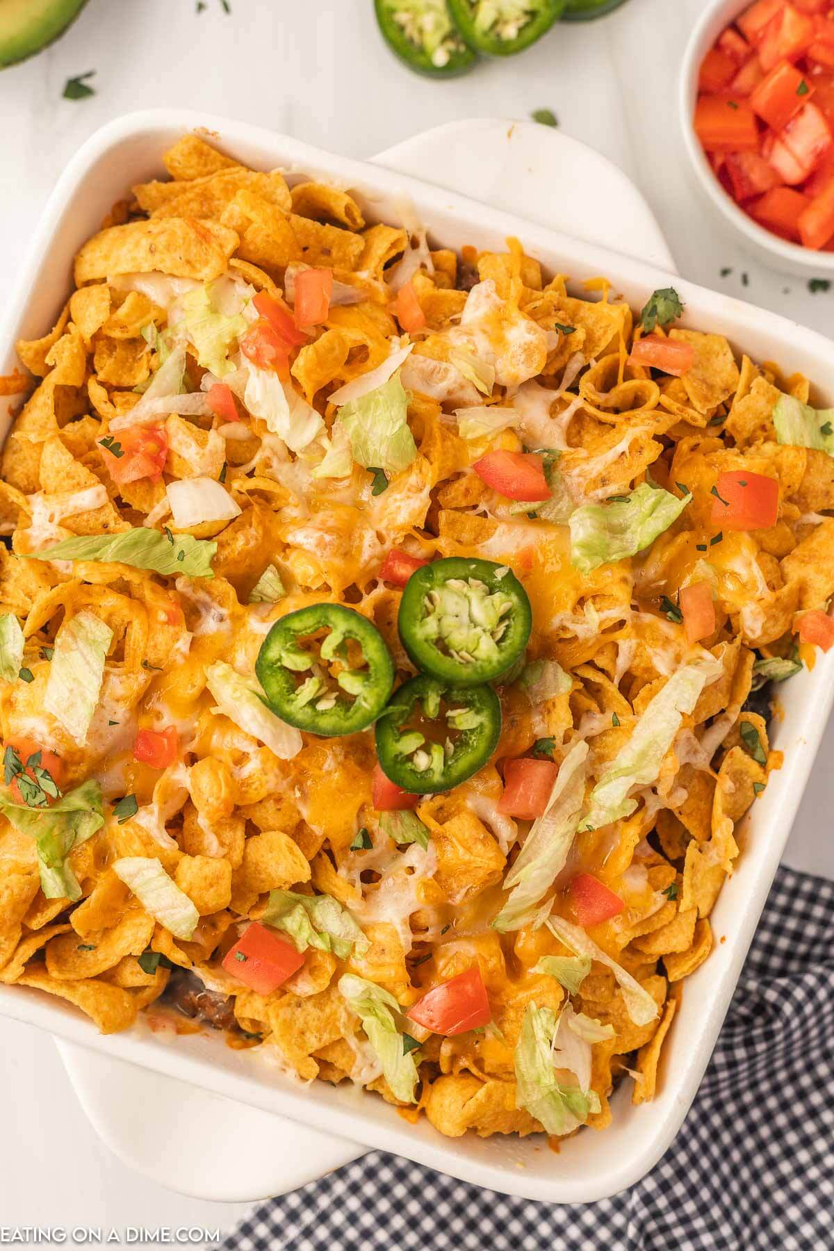 Walking Taco Casserole topped with slice jalapenos