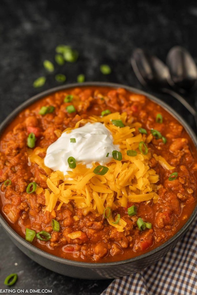 a bowl of pumpkin chili topped with chili and sour cream