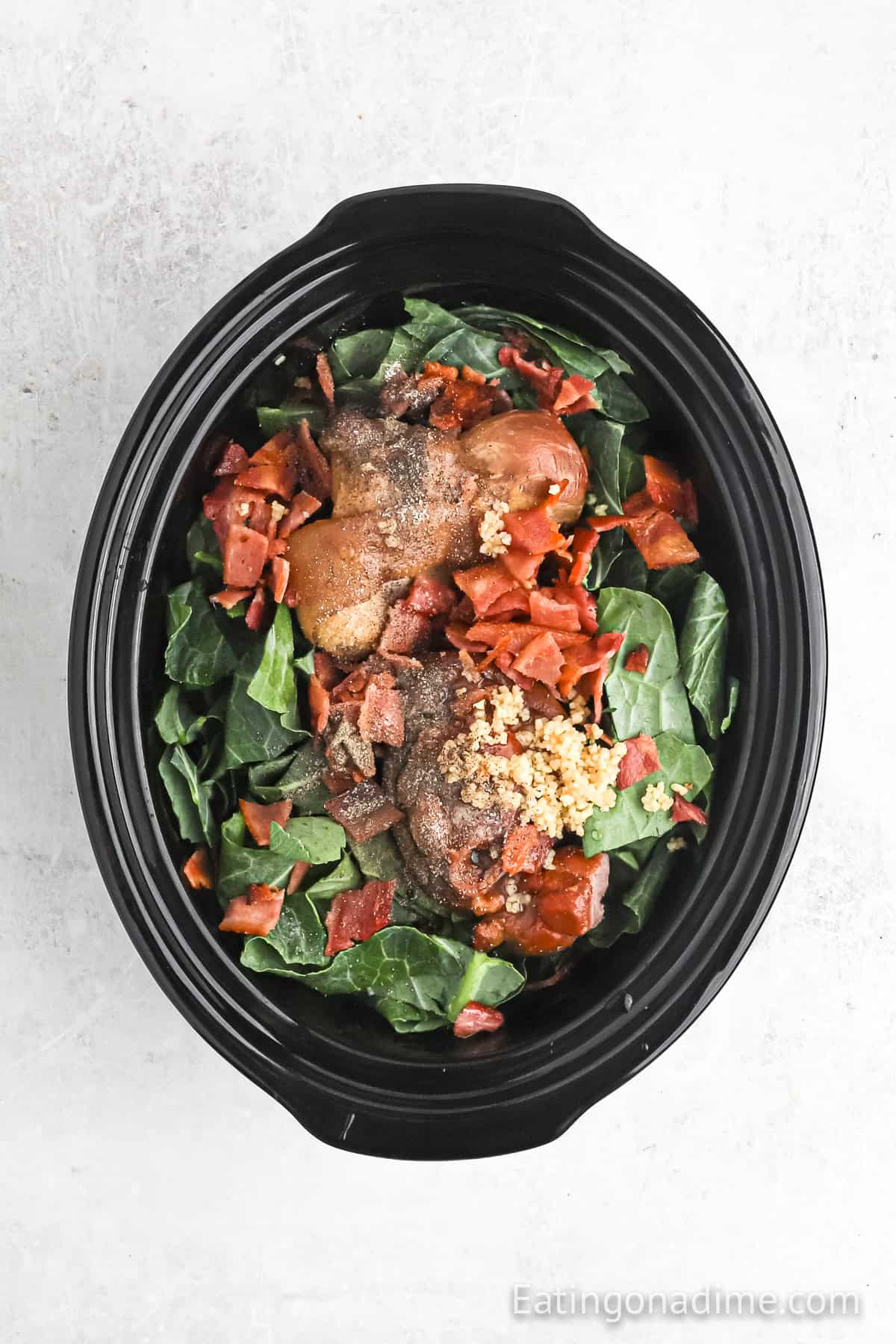 Greens topped with ham hocks, bacon and spices.