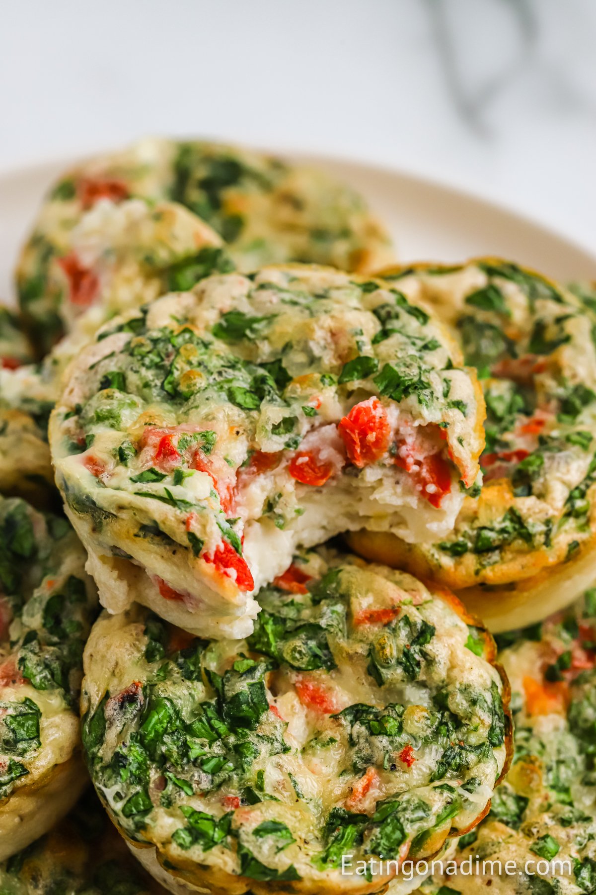 Egg White Bites stacked on a white plate