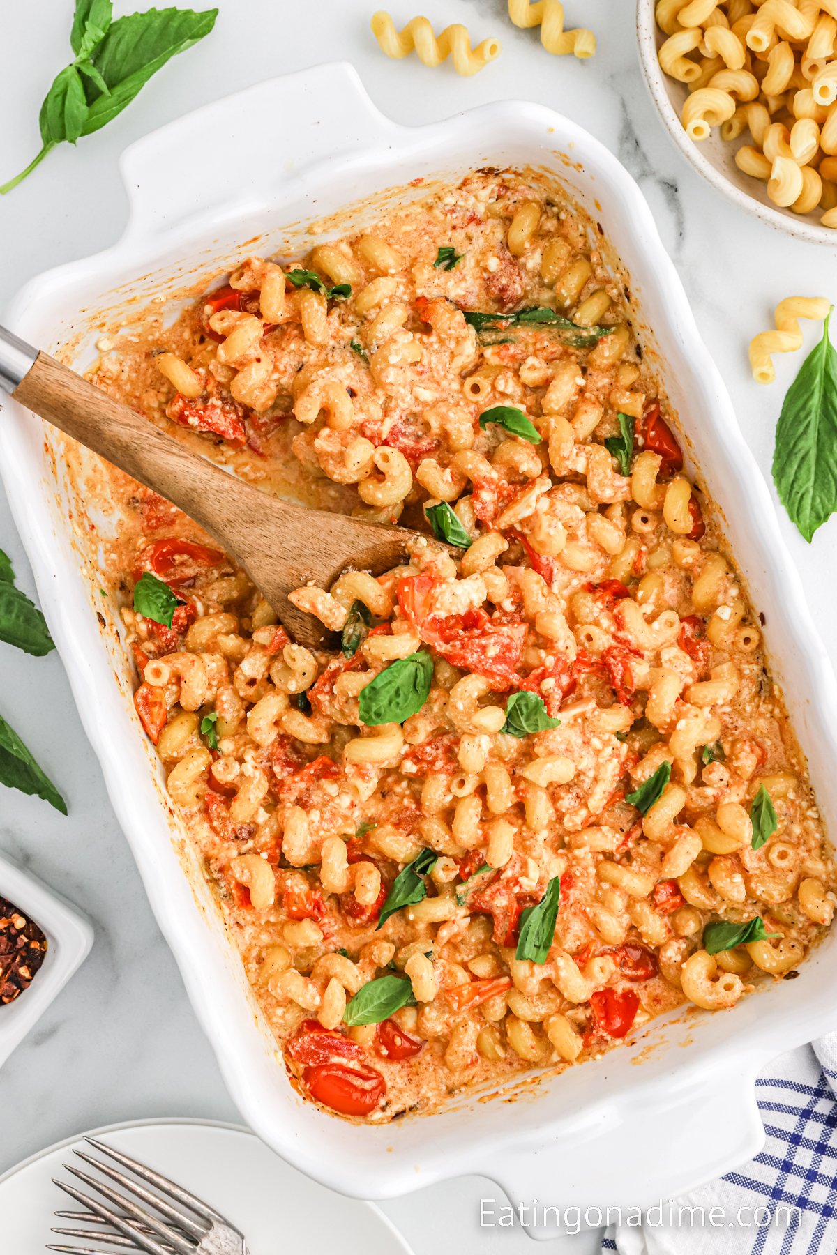 Tiktok Feta Pasta Dish in a baking dish with a wooden spoon