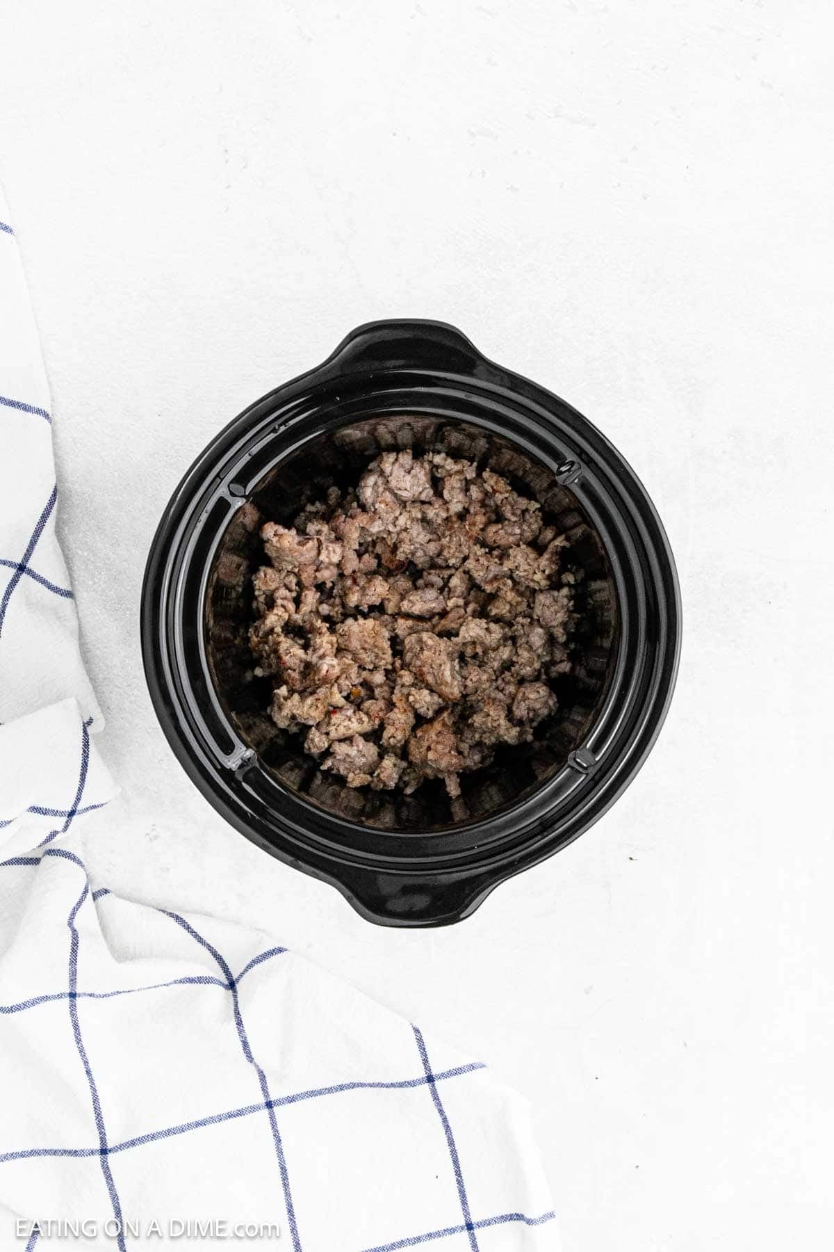 Ground cooked sausage in the crock pot.