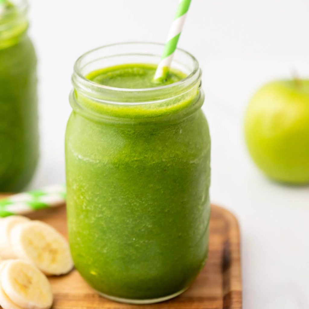 Green Smoothie in a mason jar with a striped straw