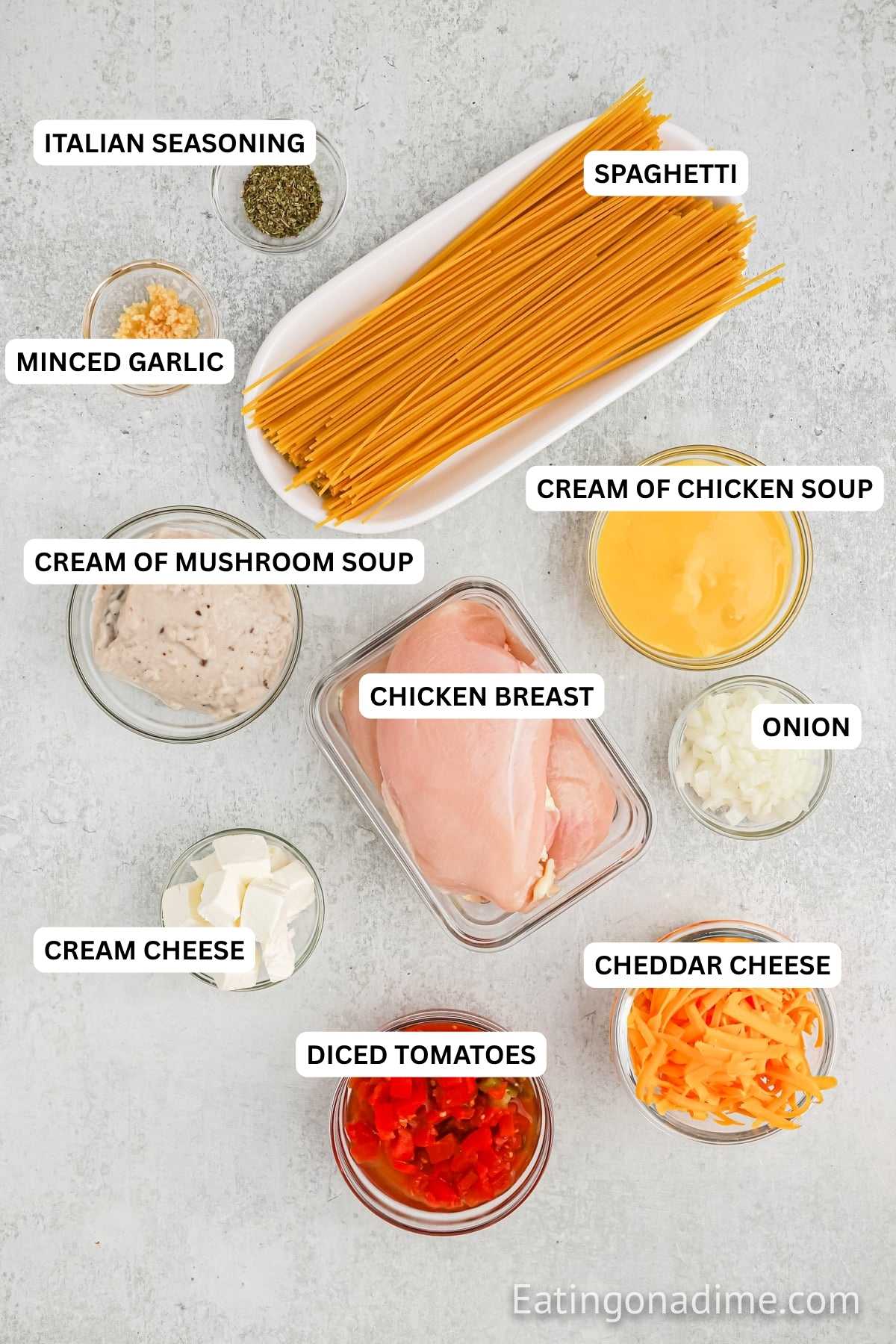 Crock Pot Cheesy Chicken Spaghetti Recipe is a creamy and delicious twist on traditional spaghetti. It is so easy to prepare and a tasty dinner idea. Ingredients for recipe - chicken breasts, diced tomatoes, cream of chicken soup, cream of mushroom soup, onion, minced garlic, Italian seasoning, cream cheese, cheddar cheese and spaghetti.