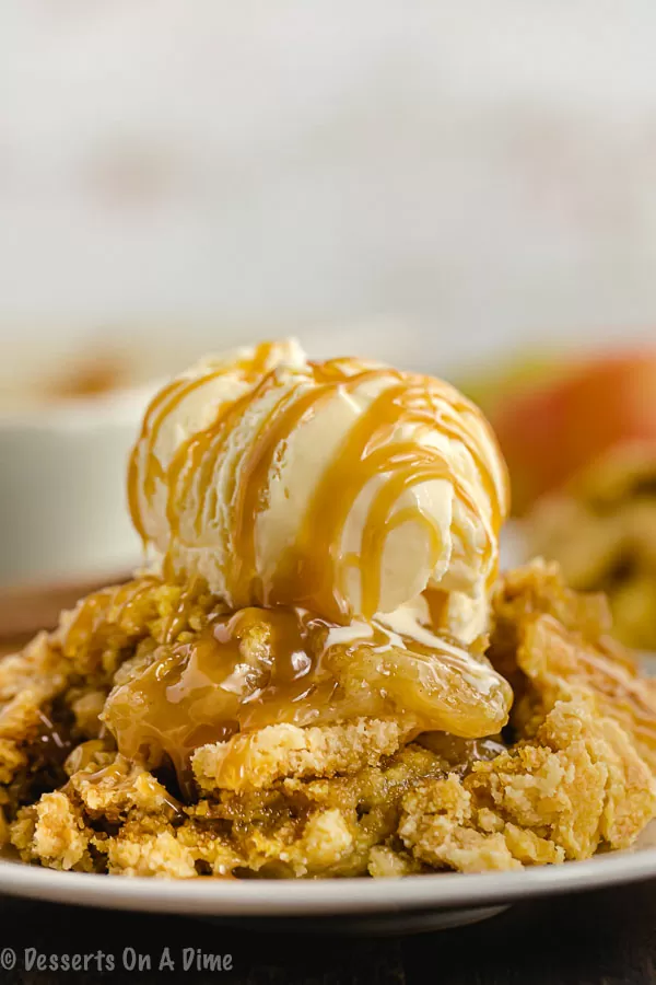 Caramel Apple Dump Cake with ice cream on top.  Drizzled with caramel sauce on top as well.  