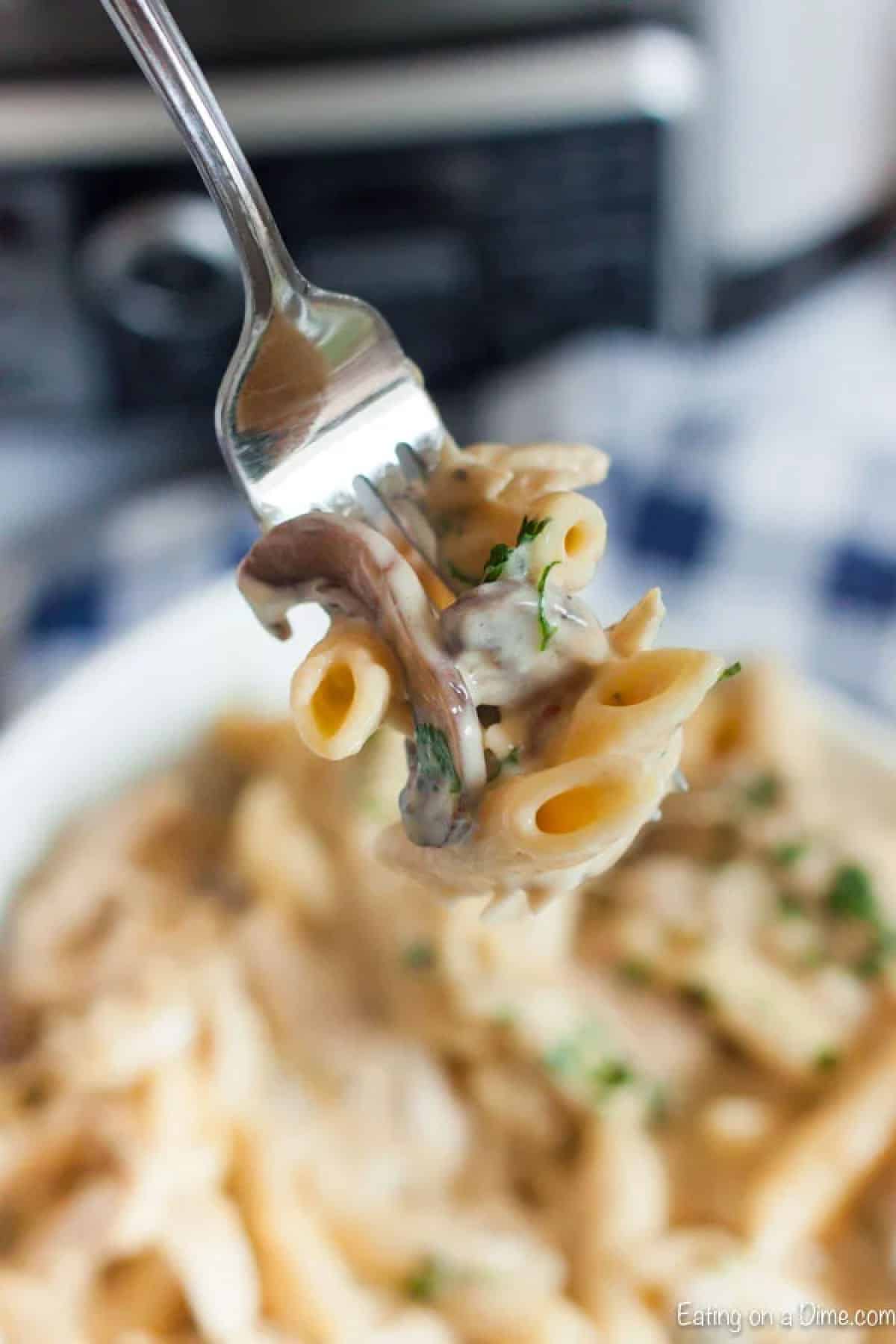 Creamy Cheesy Pasta a bite on a fork