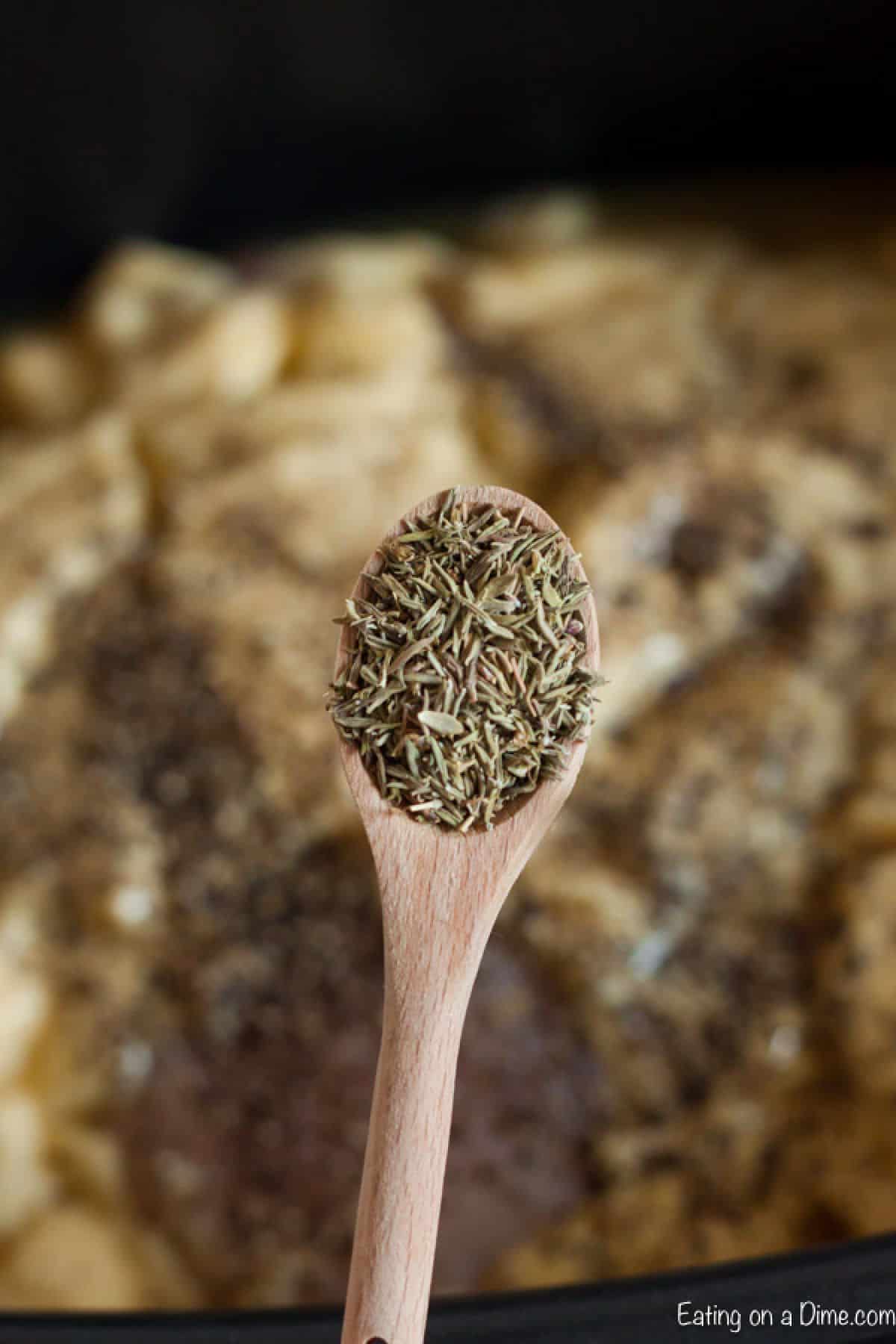 Adding the seasoning to the slow cooker