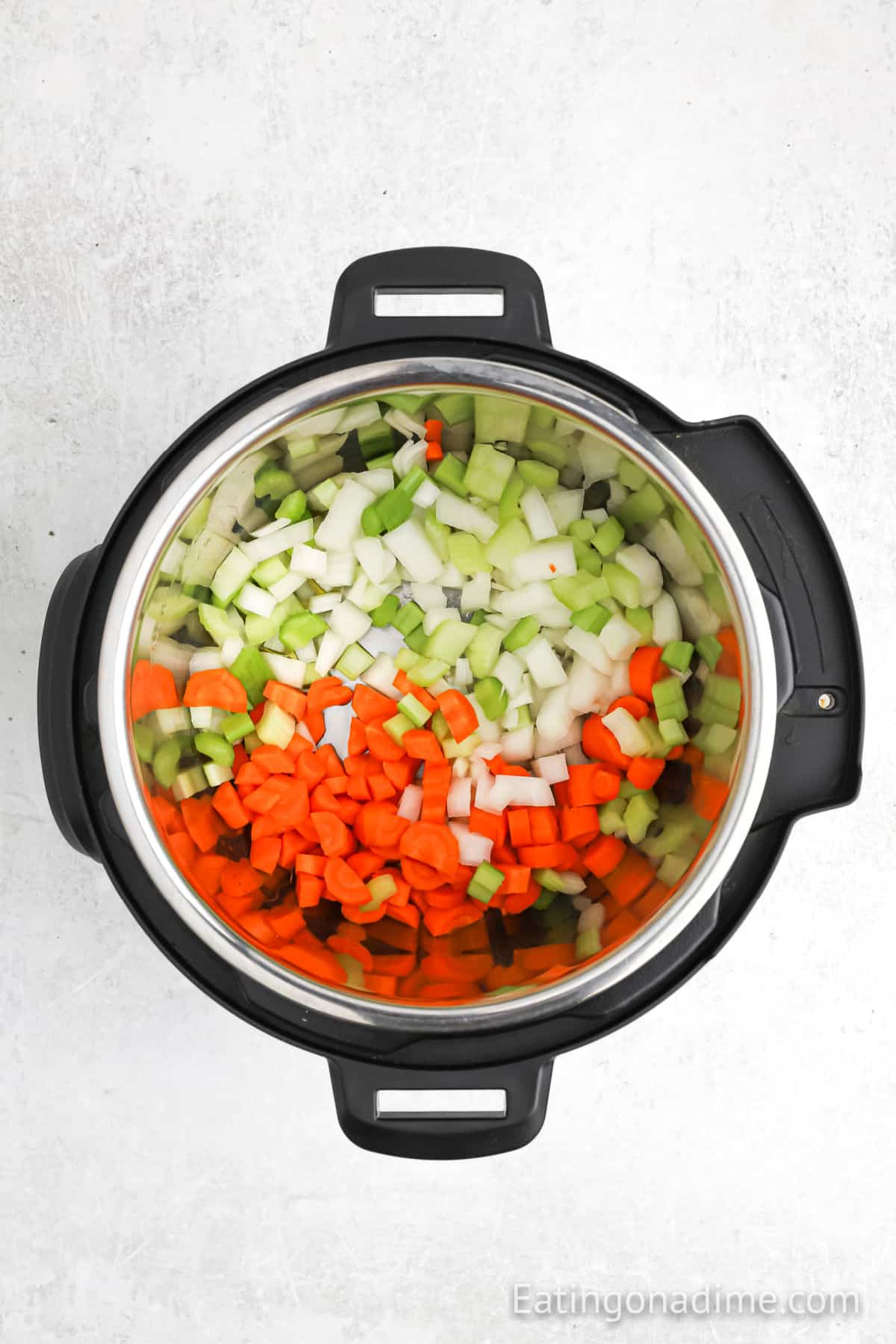 Chopped celery, onions and carrots in the instant pot.