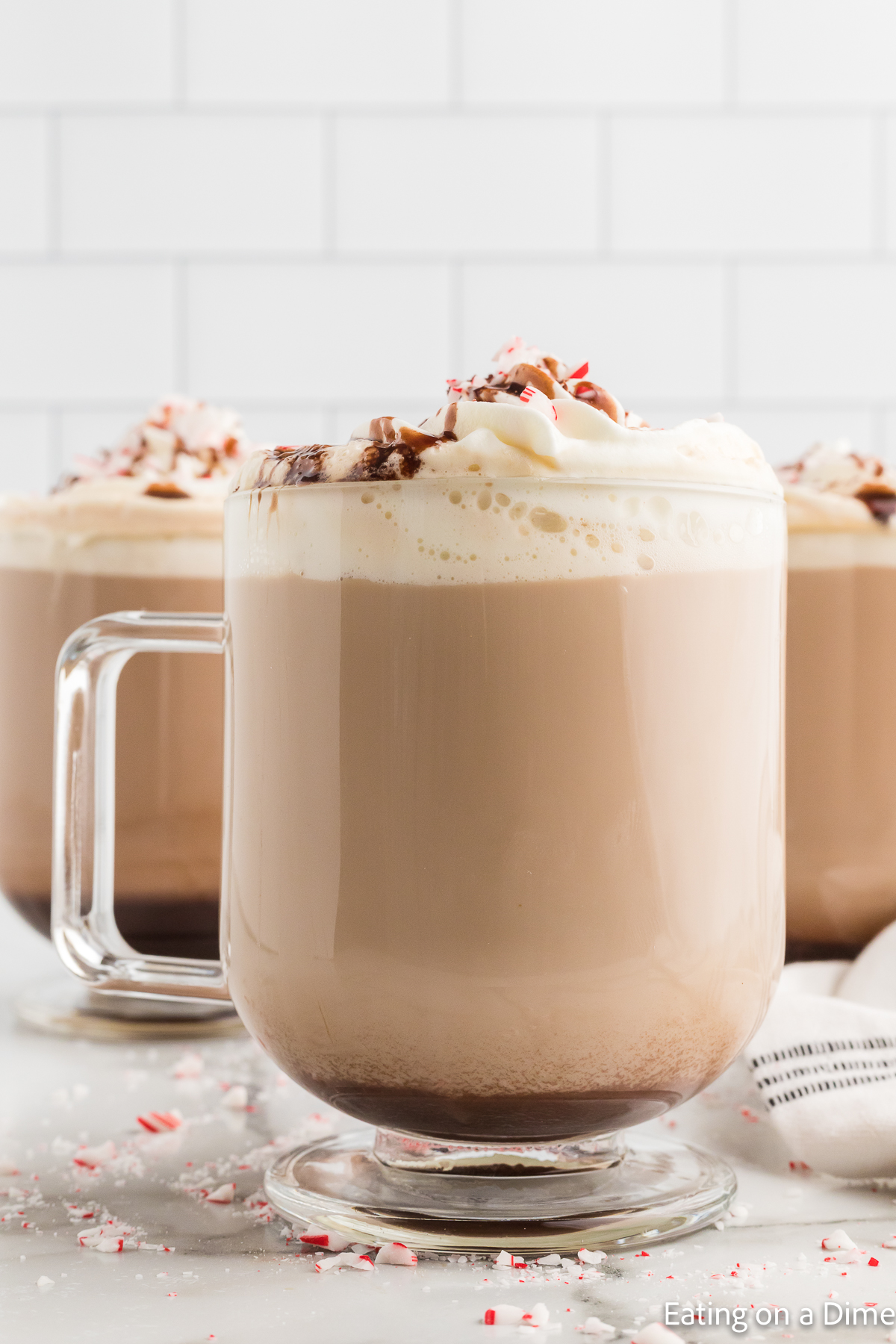 Close up image of starbucks peppermint mocha in a clear mug. 