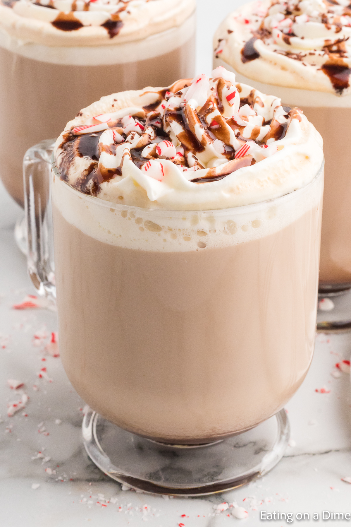Close up image of starbucks peppermint mocha in a clear mug. 