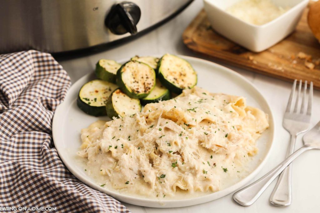 Chicken Alfredo Lasagna on a plate with a side of zucchini