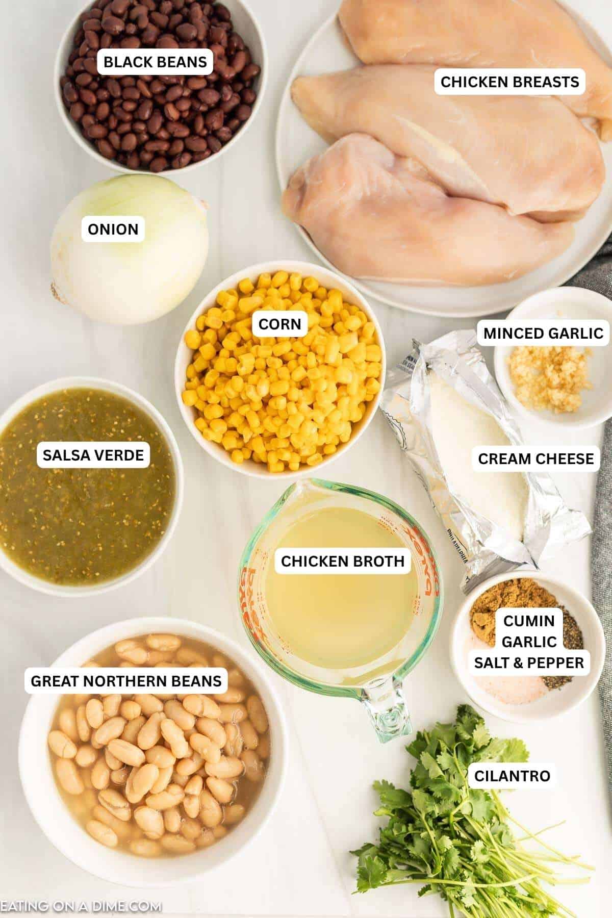 Crock pot cream cheese chicken chili recipe has everything you love about classic chili but with a delicious cream broth. This chili is easy and delicious. Ingredients for recipe: black beans, chicken breasts, onion, corn, garlic, cream cheese, salsa verde, chicken broth, cumin, garlic, salt, pepper, great northern beans, cilantro.