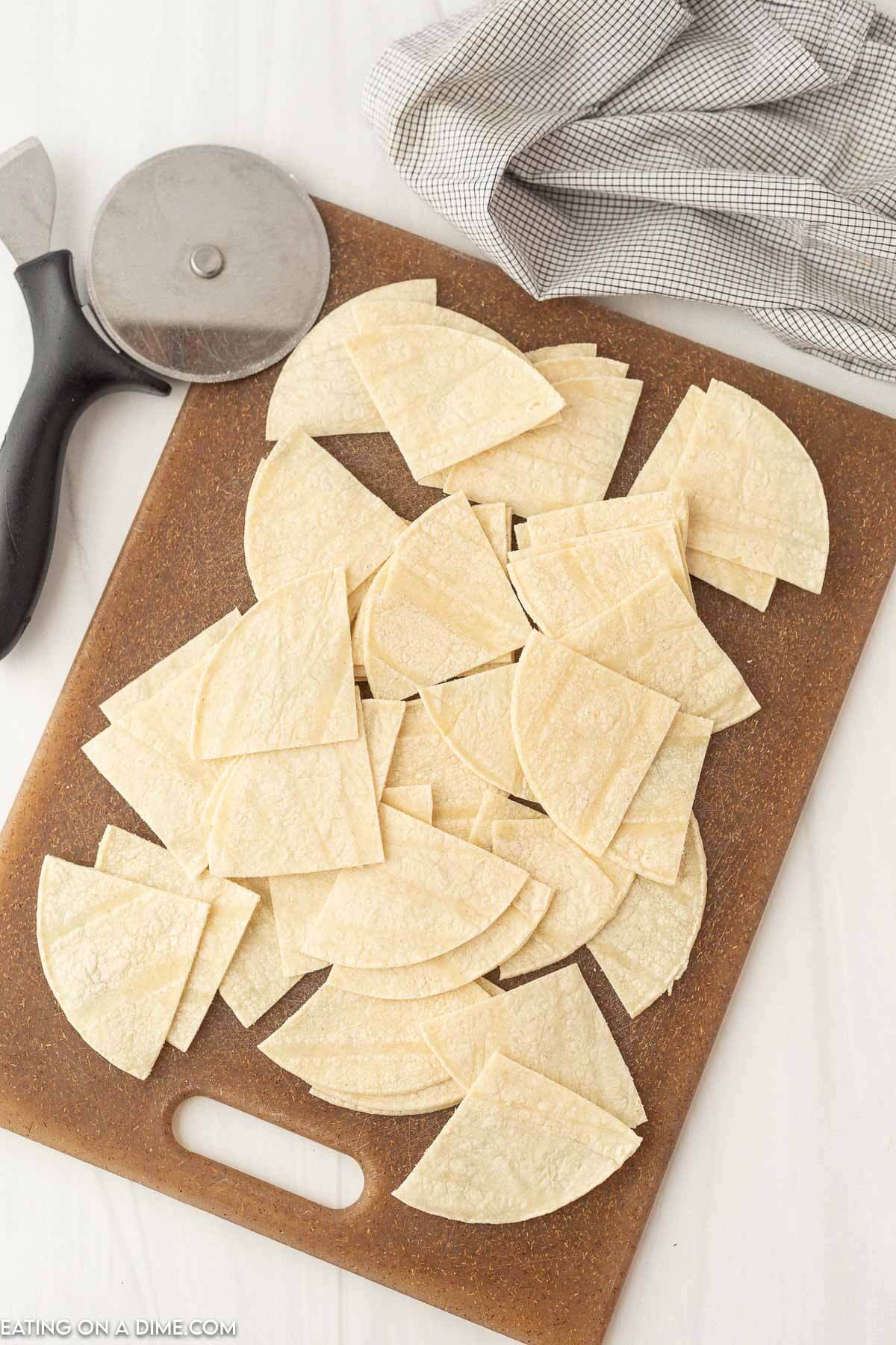 Cutting the corn tortillas on the cutting board