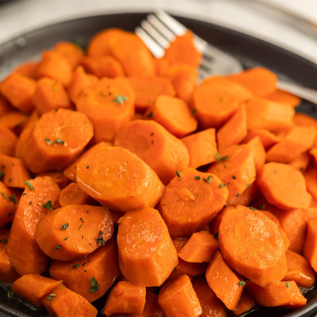 Close up image of glazed carrots on a plate