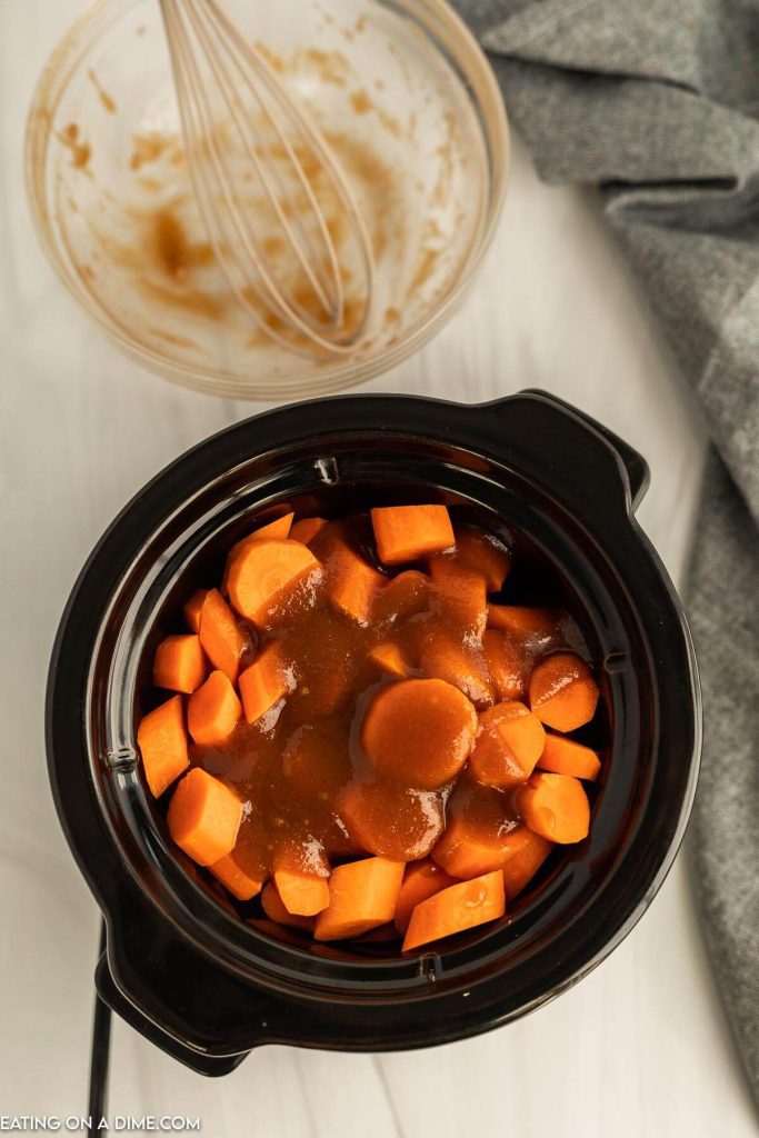 Adding the brown sugar glazed to the carrots in the slow cooker