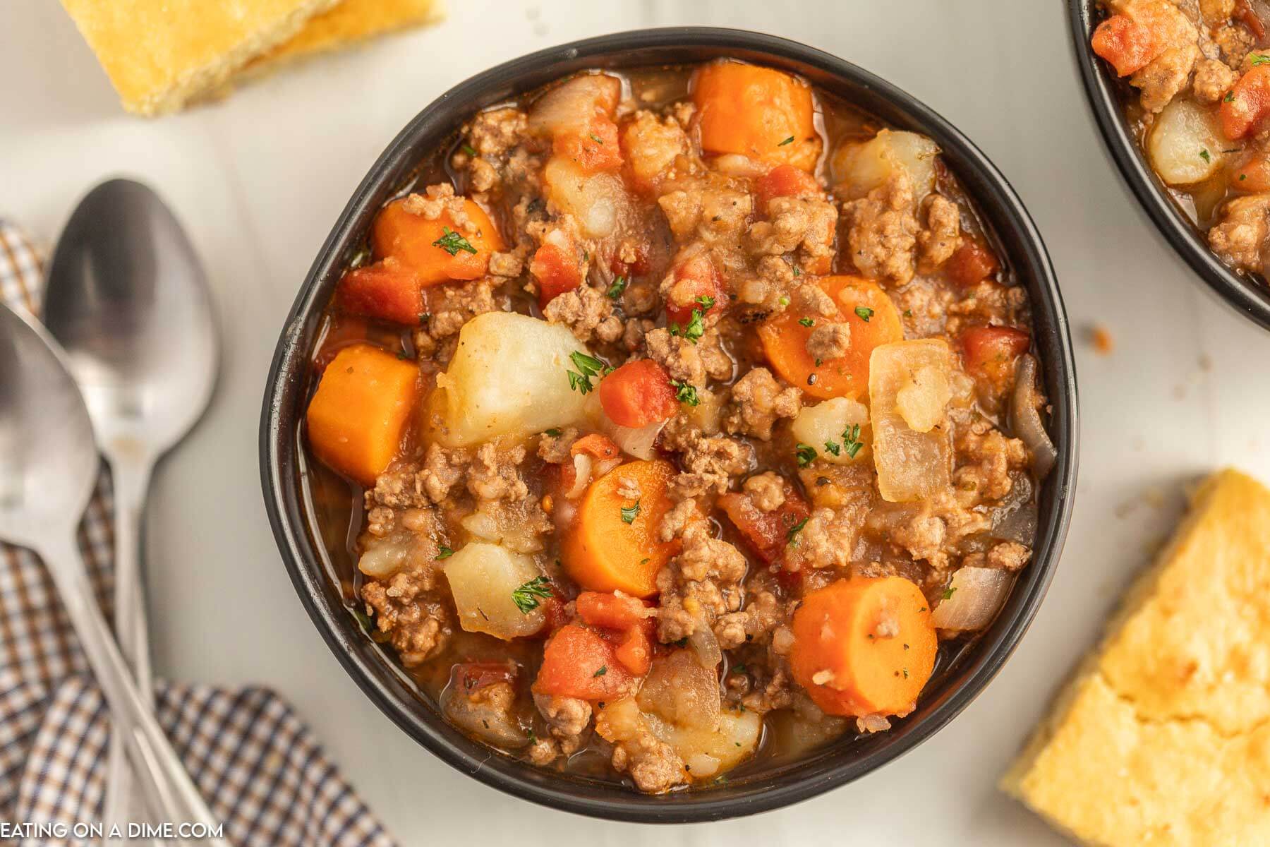 Close up image of poor mans stew in a black bowl