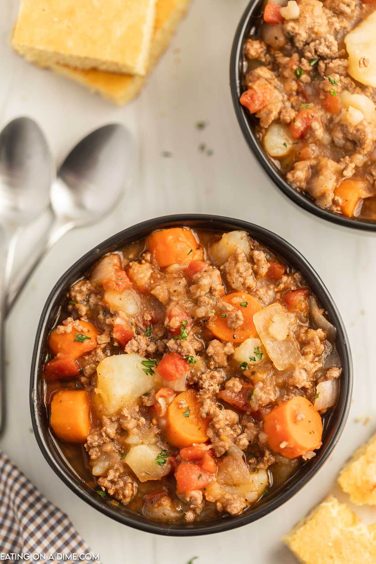 Close up image of poor mans stew in a black bowl