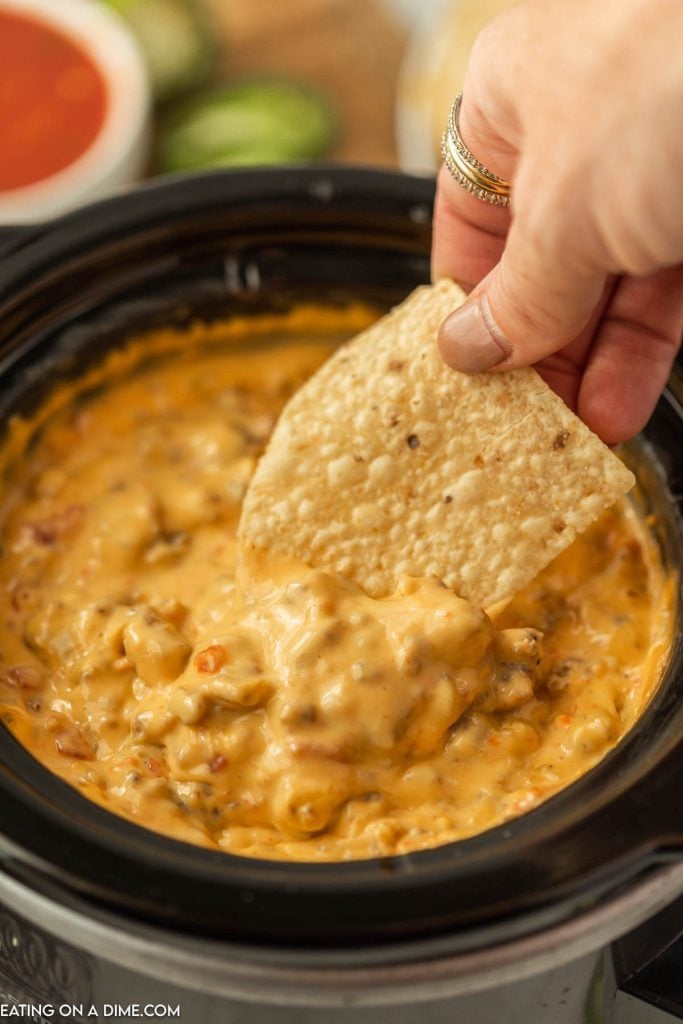 Sausage Cheese Dip in the Slow Cooker with a bite on a chip
