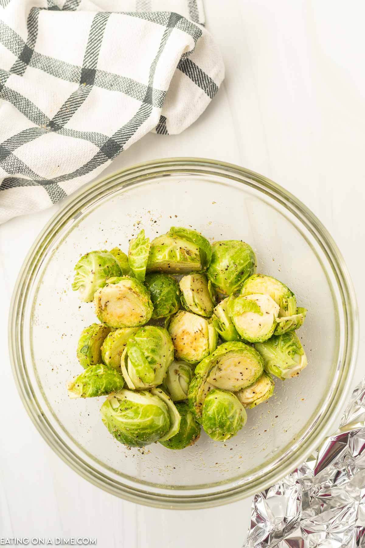 Place brussel sprouts in a bowl with seasoning. 