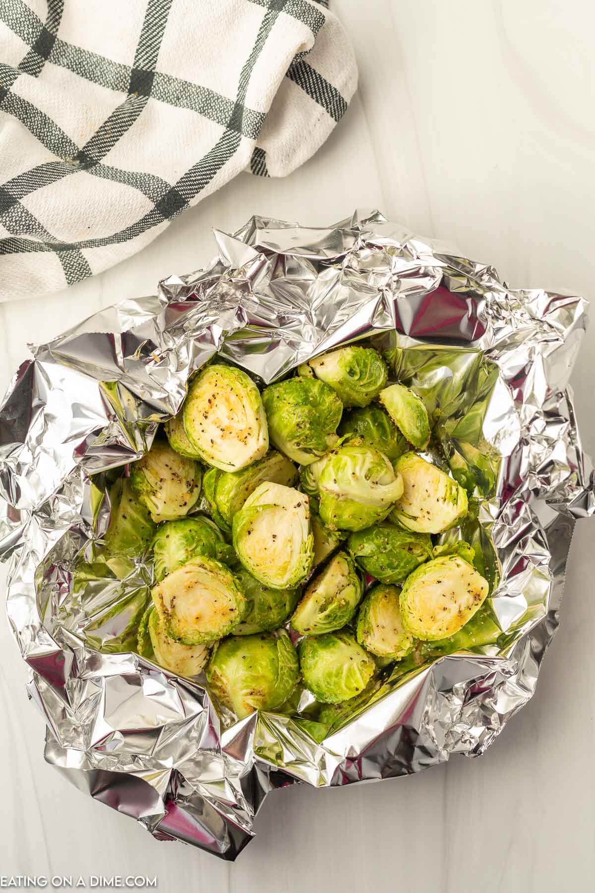 Add the seasoned brussel sprouts to the foil and make a foil packet. 